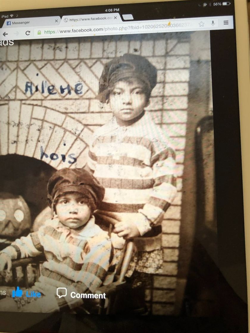 Before: an old photo of two children, photographed off a tablet screen